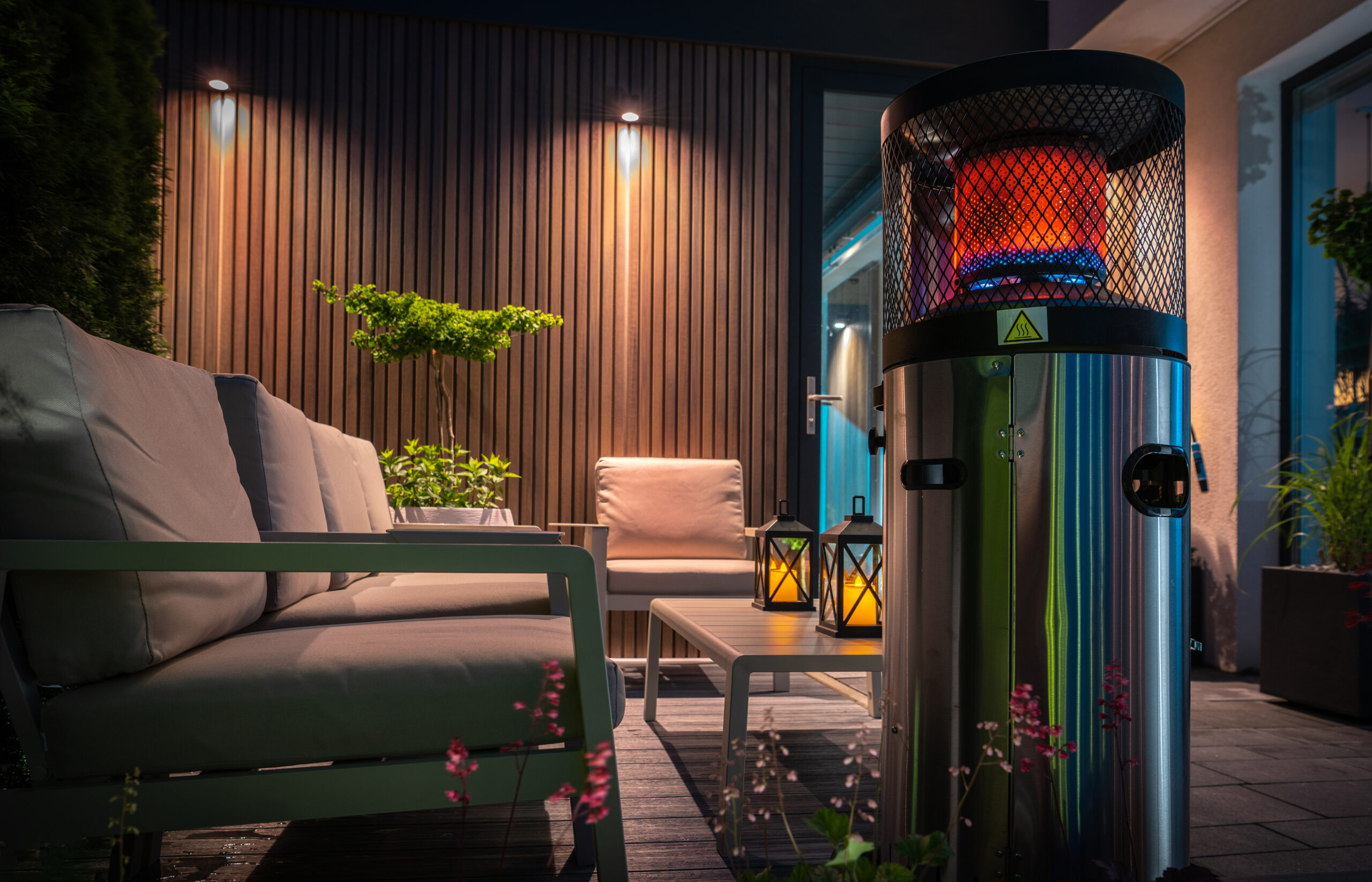 Modern Cozy Patio with Gas Heater Warming the Area During Cold Summer Evening. Residential Backyard Design.
