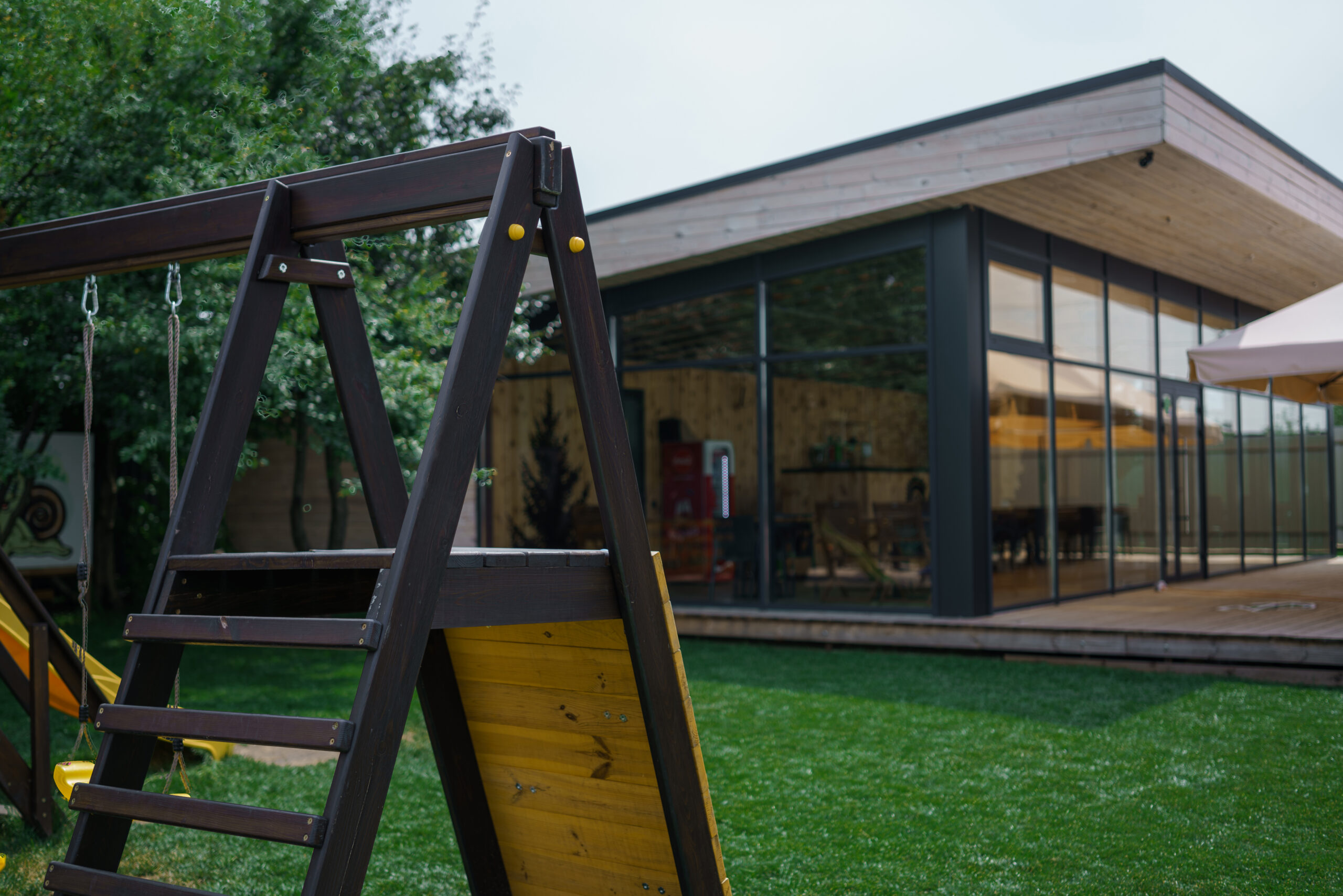 Elegant wooden home terrace with balcony. doors from bathroom and bedroom. Panorama of spacious terrace with wooden floor and furniture and amazing view.